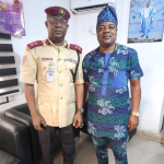 The FRSC Sector Commander, Corps Commander Sanya Adeoye, in a handshake with Ekiti State Commissioner for Transport, Kolawole Ajobiewe.