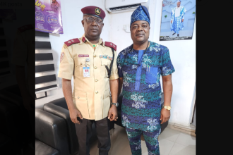 The FRSC Sector Commander, Corps Commander Sanya Adeoye, in a handshake with Ekiti State Commissioner for Transport, Kolawole Ajobiewe.