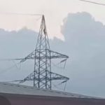 man on high tension pole