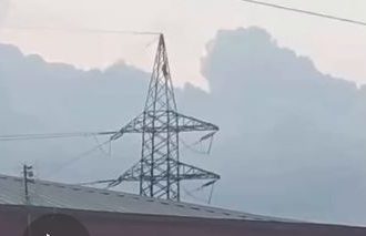 man on high tension pole
