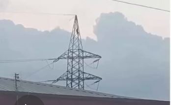 man on high tension pole